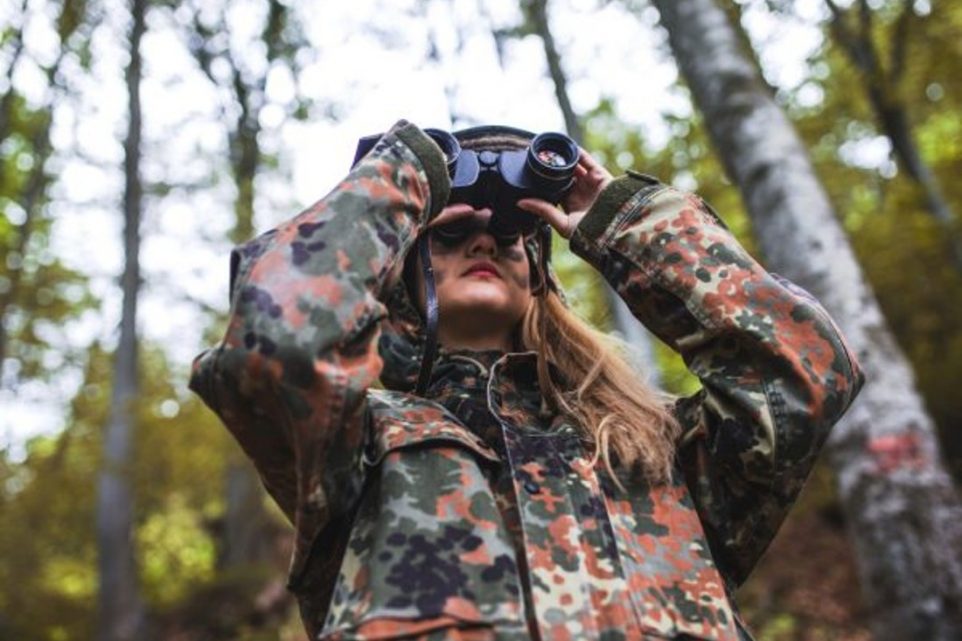 Woman using binoculars outdoors