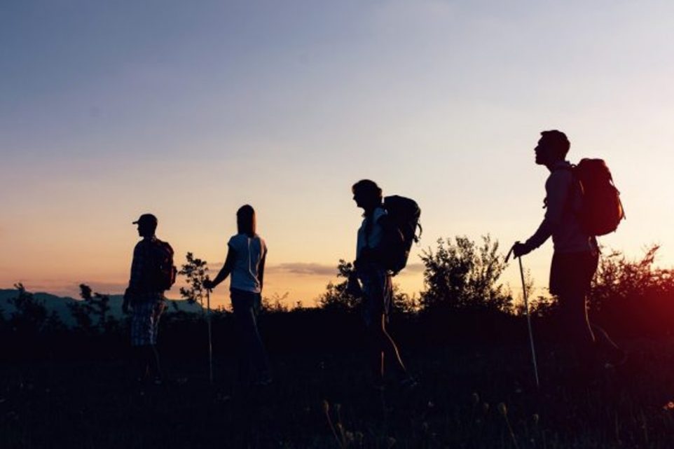 People hiking at sunset