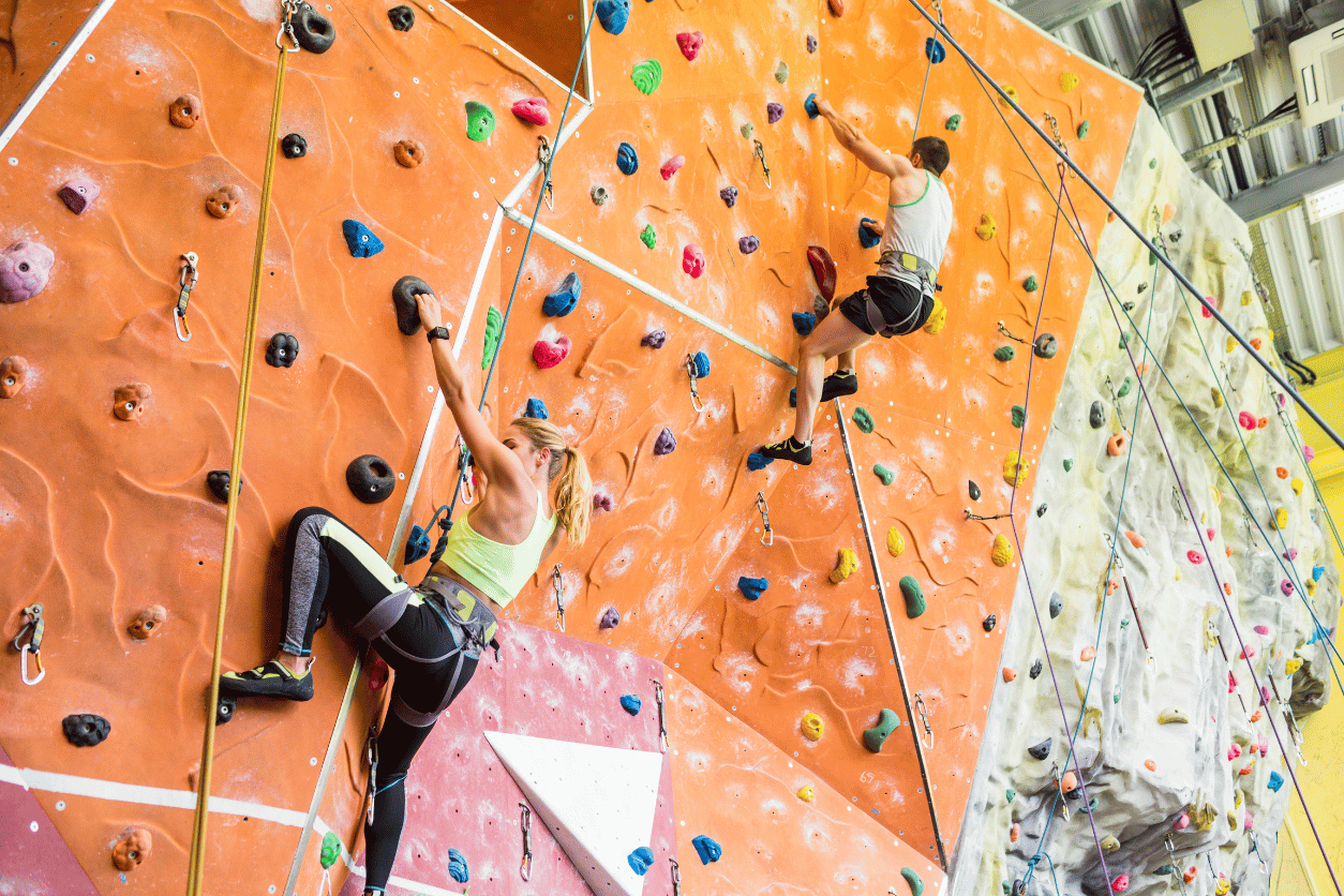 man and woman rock climbing